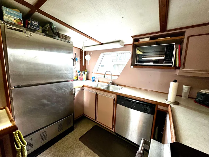 Western Shore Yacht Photos Pics 1989 Custom Expedition Yacht kitchen with stainless steel appliances and modern amenities.
