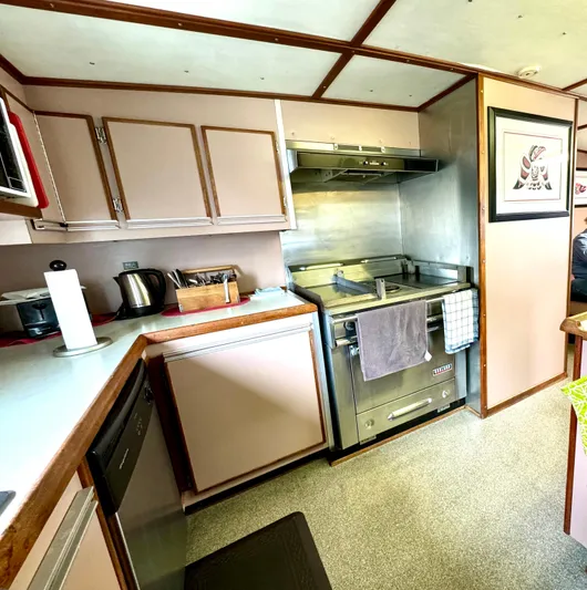 Western Shore Yacht Photos Pics 1989 Custom Expedition Yacht kitchen with modern appliances and wood cabinetry.