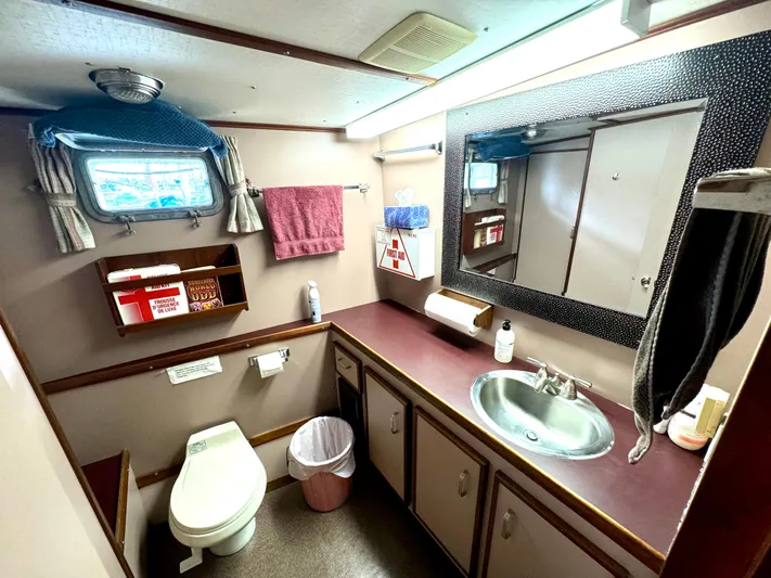 Western Shore Yacht Photos Pics Bathroom interior of 1989 Custom Expedition Yacht with sink, mirror, and toilet.