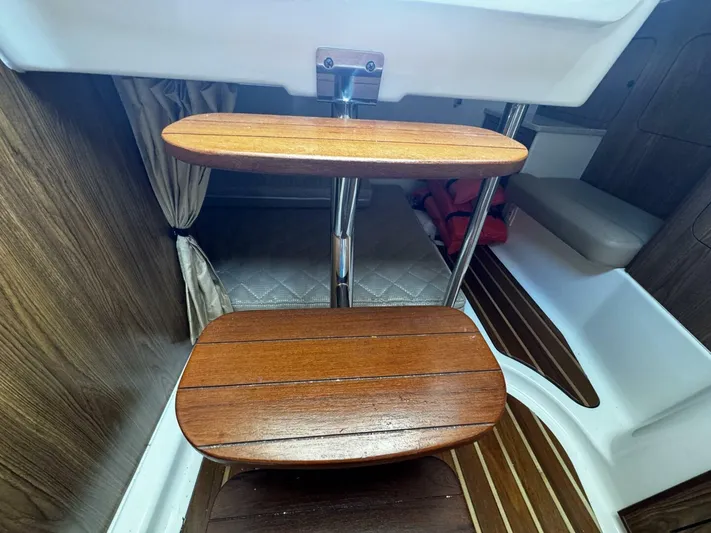 Liberty Yacht Photos Pics Wooden steps inside 2010 Pursuit OS 345 Offshore boat cabin.