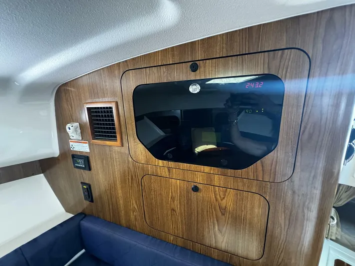 Liberty Yacht Photos Pics Interior cabin of a 2010 Pursuit OS 345 Offshore boat with wood paneling.