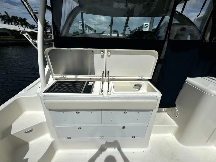 Liberty Yacht Photos Pics 2010 Pursuit OS 345 Offshore boat with open storage compartments and sink.