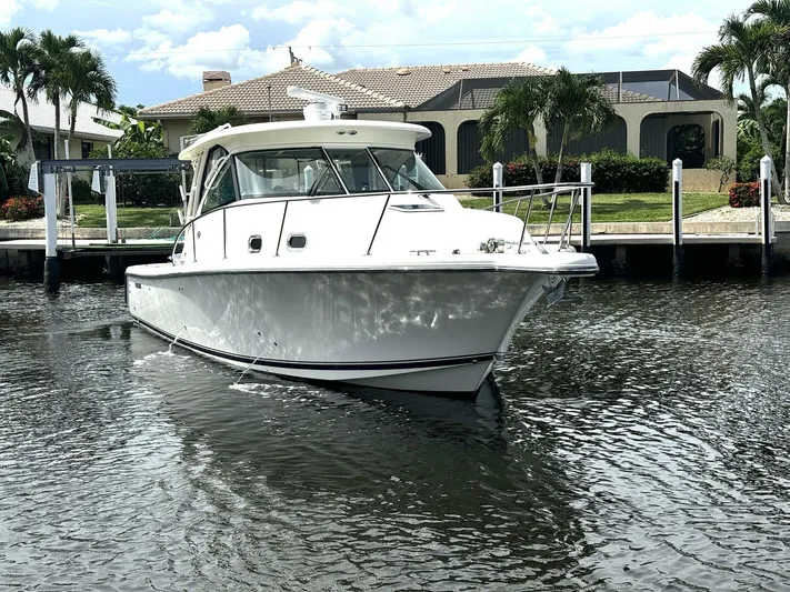 Liberty Yacht Photos Pics 2010 Pursuit OS 345 Offshore boat docked in a residential canal.