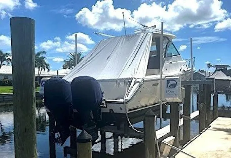 Liberty Yacht Photos Pics 2010 Pursuit OS 345 Offshore boat docked with twin outboard engines.
