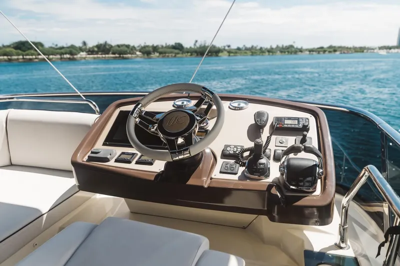  Yacht Photos Pics Beneteau Monte Carlo 5 yacht helm, 2015 model, overlooking serene blue waters.
