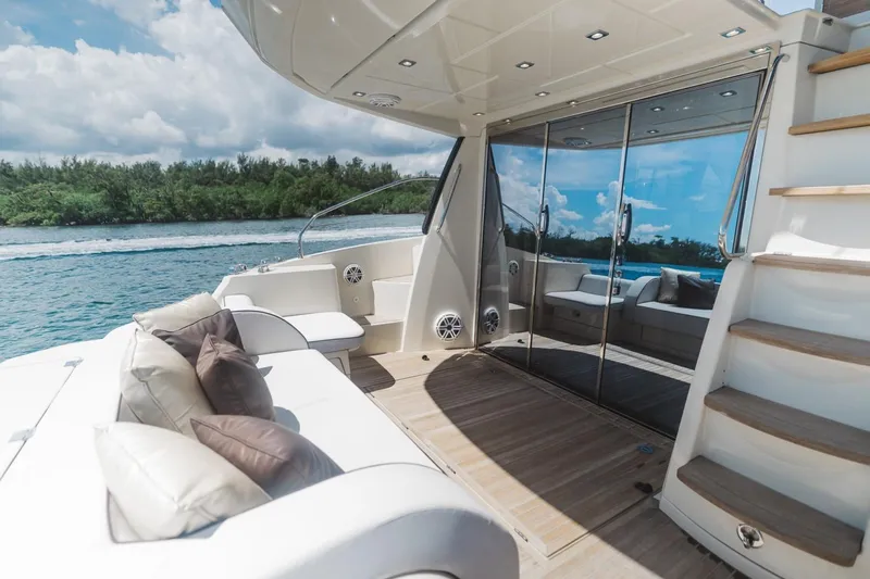  Yacht Photos Pics Luxurious 2015 Beneteau Monte Carlo 5 yacht deck with seating, stairs, and scenic water view.