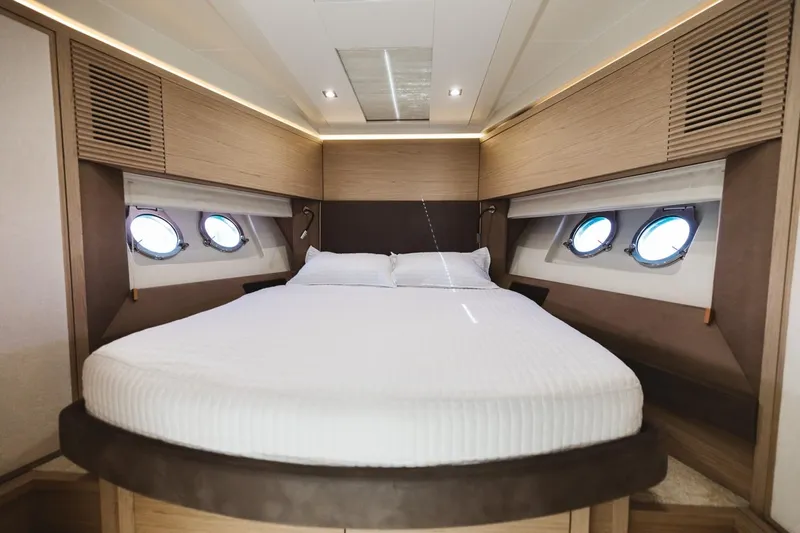  Yacht Photos Pics Luxurious bedroom interior of 2015 Beneteau Monte Carlo 5 yacht with round windows.