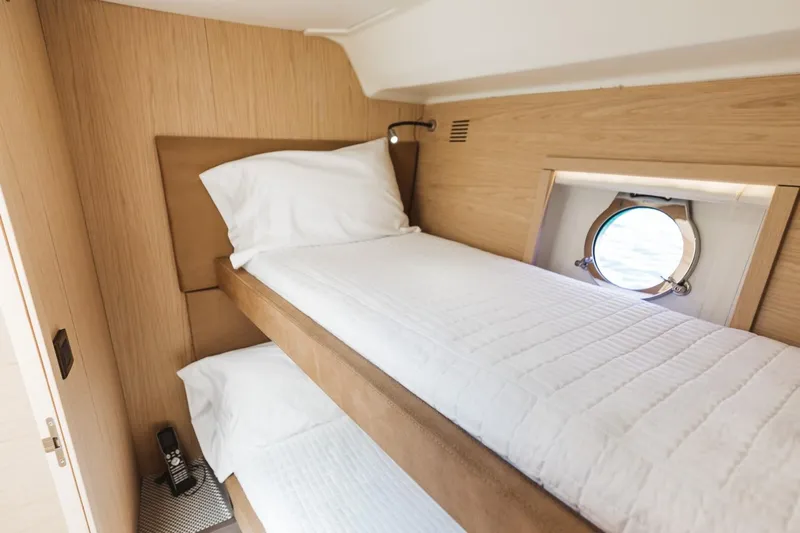 Yacht Photos Pics Cozy twin cabin in 2015 Beneteau Monte Carlo 5 yacht with porthole view.