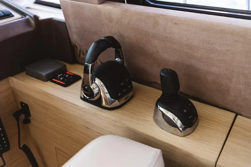  Yacht Photos Pics 2015 Beneteau Monte Carlo 5 yacht controls with joystick and throttle on wooden console.