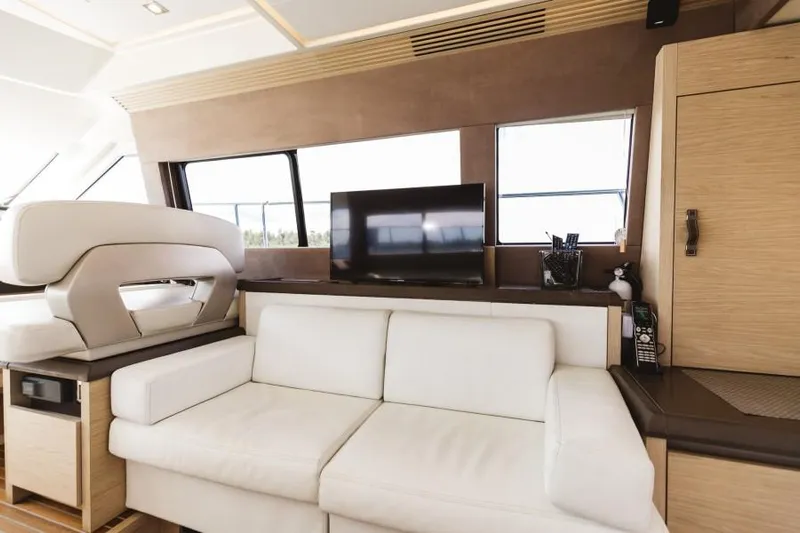  Yacht Photos Pics Luxurious interior of 2015 Beneteau Monte Carlo 5 yacht with white sofa and TV.
