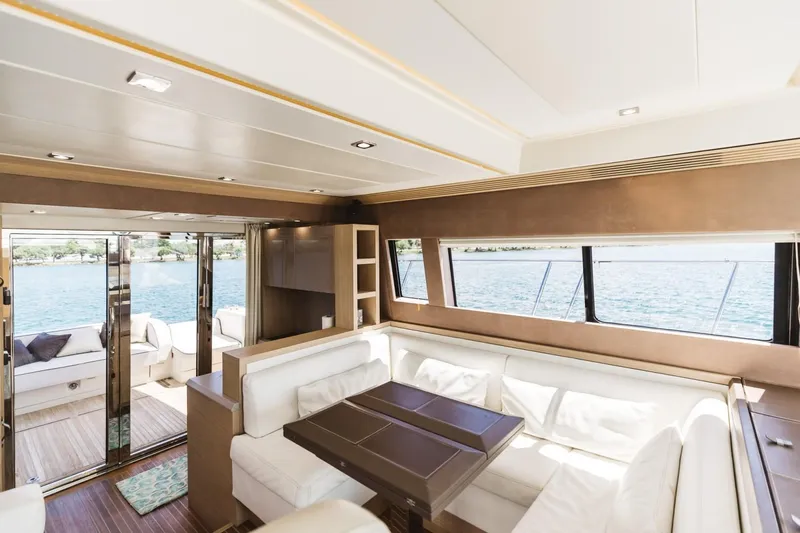  Yacht Photos Pics Luxurious interior of 2015 Beneteau Monte Carlo 5 yacht with elegant seating and panoramic windows.