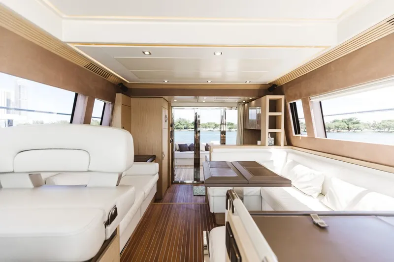 Yacht Photos Pics Luxurious interior of 2015 Beneteau Monte Carlo 5 yacht with elegant seating and wood accents.