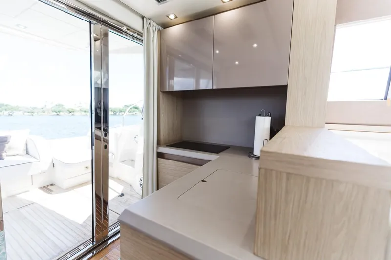  Yacht Photos Pics Interior of 2015 Beneteau Monte Carlo 5 yacht with modern kitchen and outdoor view.