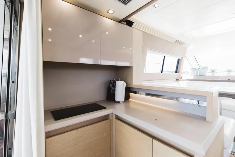  Yacht Photos Pics Modern kitchen interior on 2015 Beneteau Monte Carlo 5 yacht, featuring sleek cabinetry and appliances.