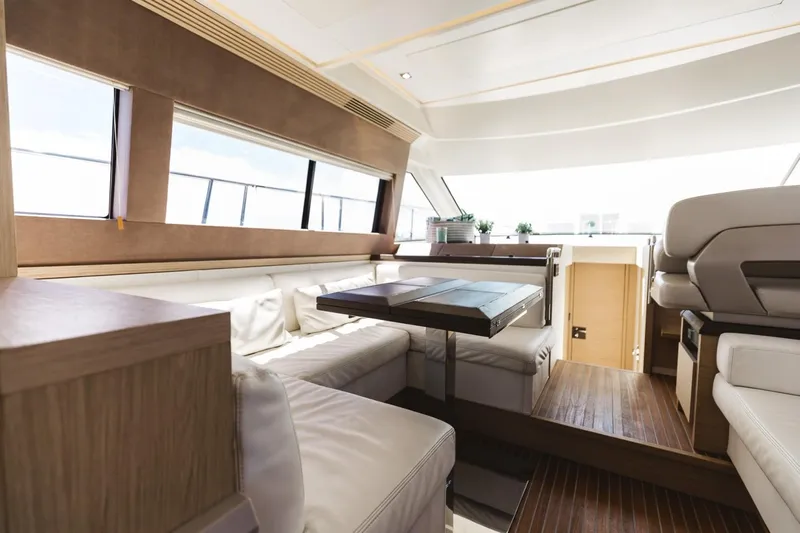  Yacht Photos Pics Luxurious interior of 2015 Beneteau Monte Carlo 5 yacht with elegant seating and wooden accents.