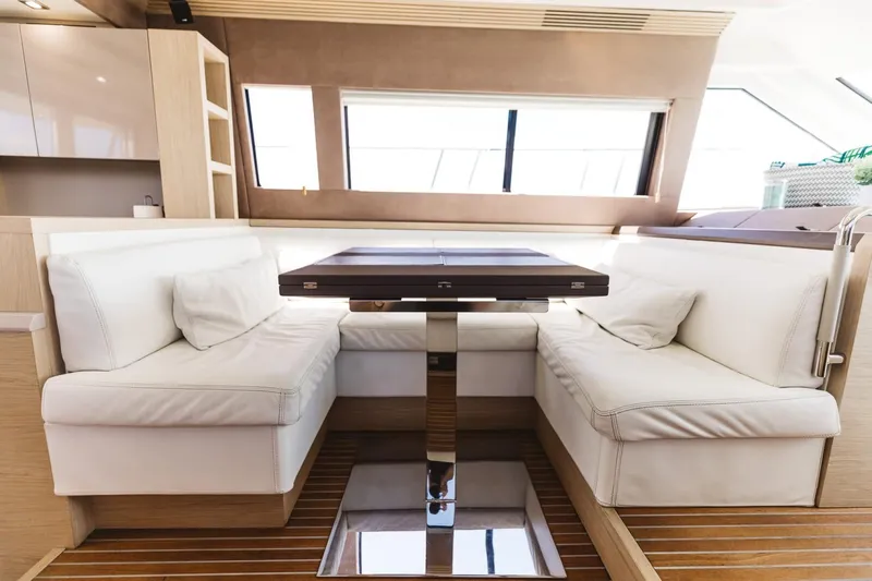  Yacht Photos Pics Luxurious interior of 2015 Beneteau Monte Carlo 5 yacht with elegant seating and table.