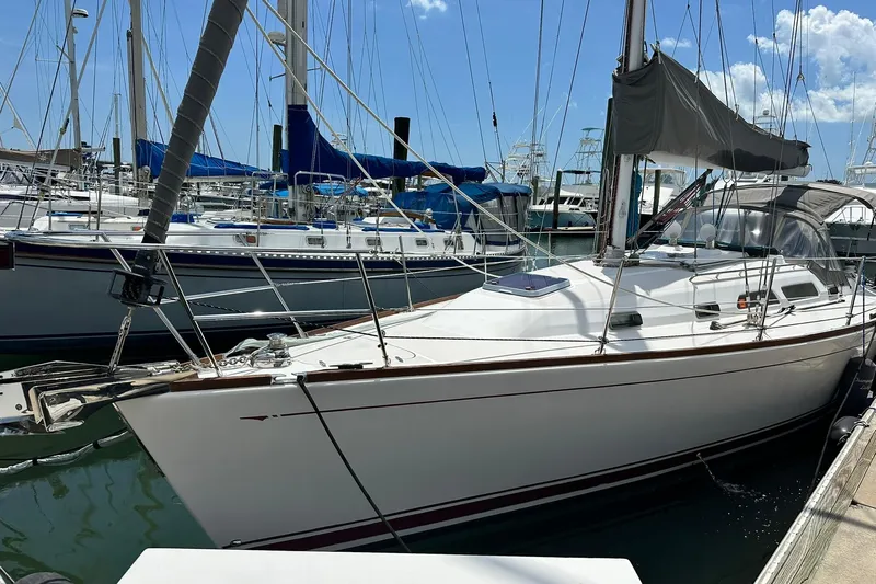 Champagne Lady Yacht Photos Pics 2007 Sabre 386 sailboat docked in a marina under a clear blue sky.