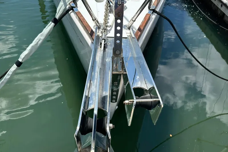 Champagne Lady Yacht Photos Pics Bow of 2007 Sabre 386 sailboat with anchor roller, docked in calm water.