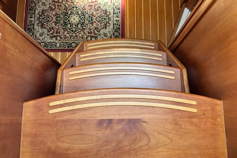 Champagne Lady Yacht Photos Pics Wooden steps inside a 2007 Sabre 386 boat, with a decorative rug visible.