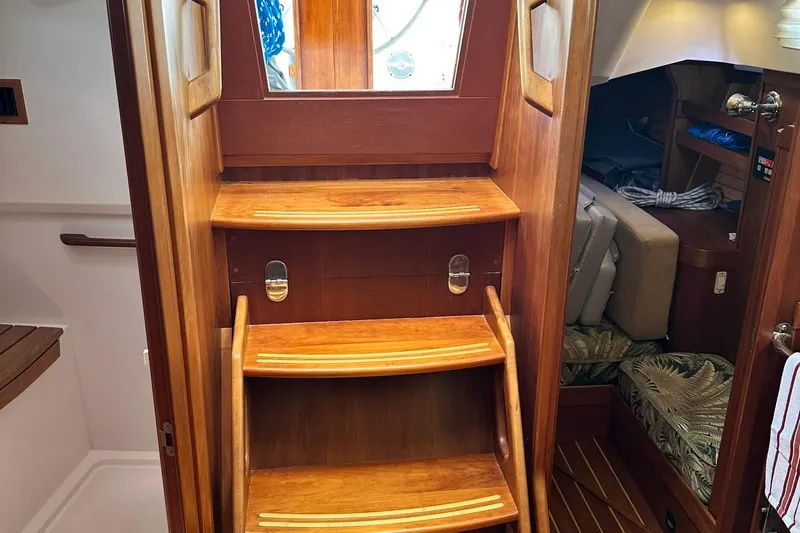 Champagne Lady Yacht Photos Pics Wooden interior stairs of a 2007 Sabre 386 sailboat, leading to cabin area.