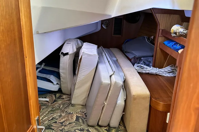Champagne Lady Yacht Photos Pics Interior storage area of a 2007 Sabre 386 sailboat with cushions and ropes.