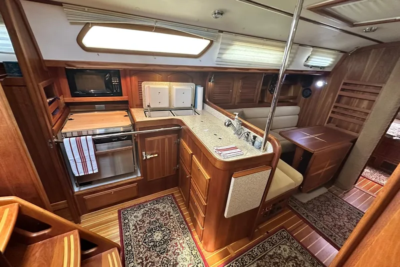 Champagne Lady Yacht Photos Pics Luxurious 2007 Sabre 386 yacht interior with wood finish, kitchen, and seating area.