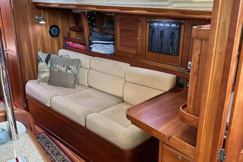 Champagne Lady Yacht Photos Pics Cozy interior of 2007 Sabre 386 yacht with beige sofa and wooden cabinetry.