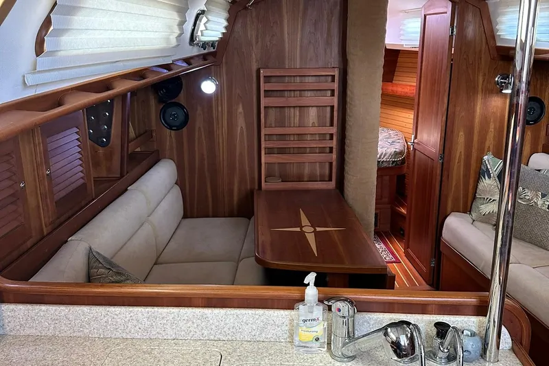 Champagne Lady Yacht Photos Pics Interior of 2007 Sabre 386 sailboat with cozy seating and wooden finishes.