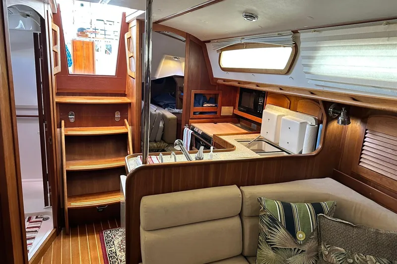 Champagne Lady Yacht Photos Pics Interior of 2007 Sabre 386 sailboat with wooden cabinetry and cozy seating area.