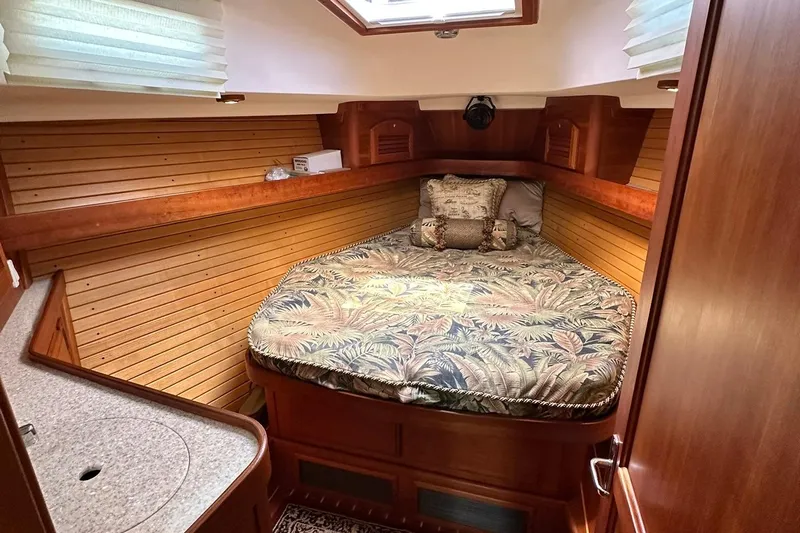 Champagne Lady Yacht Photos Pics Cozy cabin interior of 2007 Sabre 386 yacht with patterned bedding and wooden paneling.