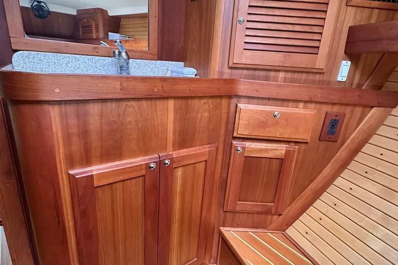 Champagne Lady Yacht Photos Pics Wooden interior of 2007 Sabre 386 yacht with sink and storage cabinets.