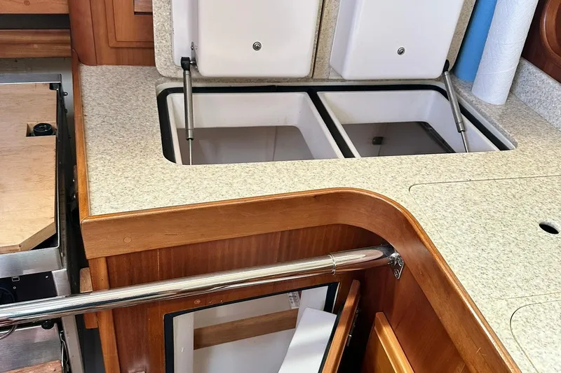 Champagne Lady Yacht Photos Pics 2007 Sabre 386 yacht interior with open storage compartments and wooden cabinetry.