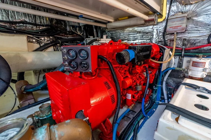 Magic Yacht Photos Pics Engine room of 1992 Tiara Yachts 4300 Open, featuring a vibrant red engine.