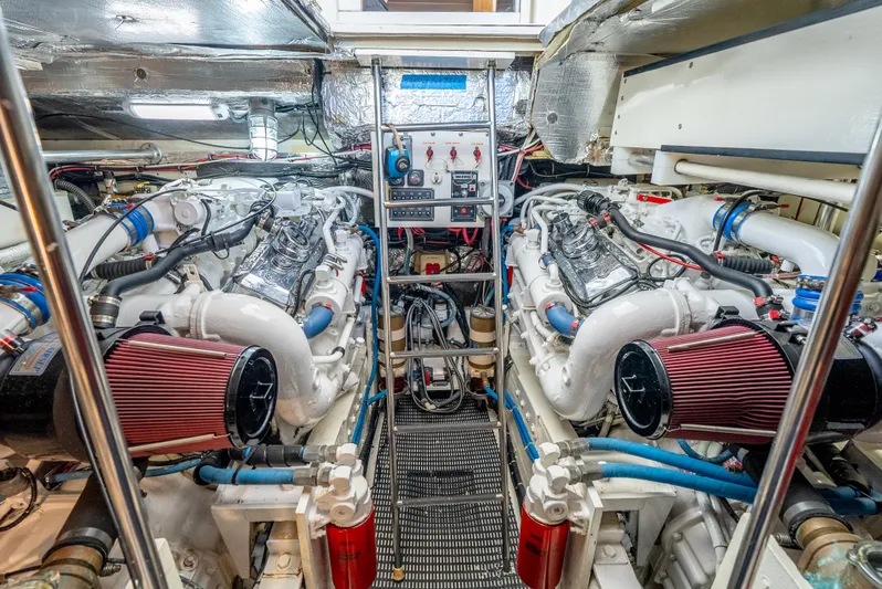 Magic Yacht Photos Pics Engine room of a 1992 Tiara Yachts 4300 Open, showcasing dual engines and mechanical systems.