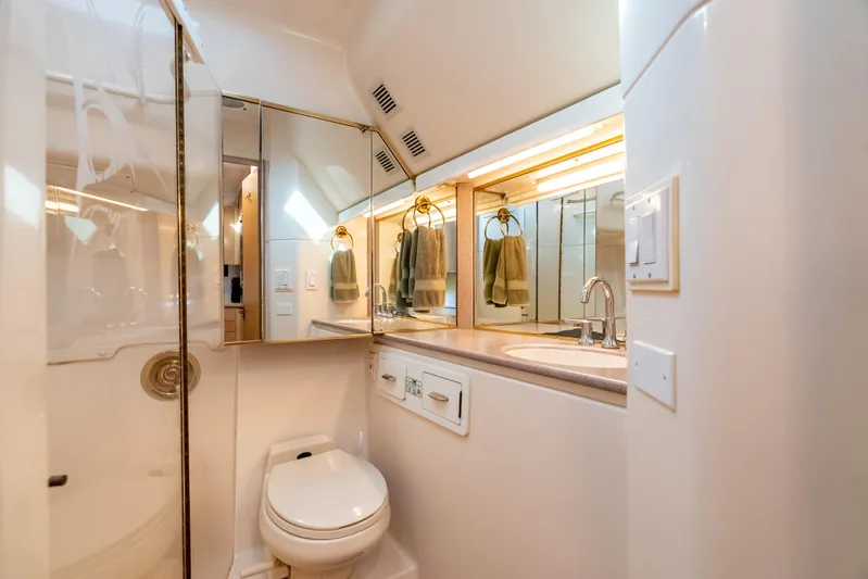 Magic Yacht Photos Pics Luxurious bathroom in 1992 Tiara Yachts 4300 Open, featuring modern fixtures and elegant design.