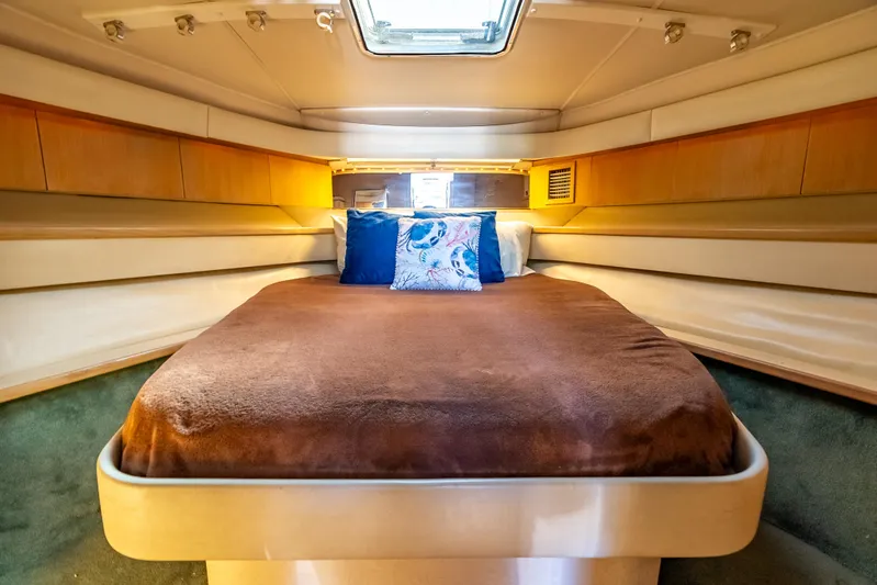 Magic Yacht Photos Pics Cozy cabin interior of 1992 Tiara Yachts 4300 Open with plush bedding and ambient lighting.