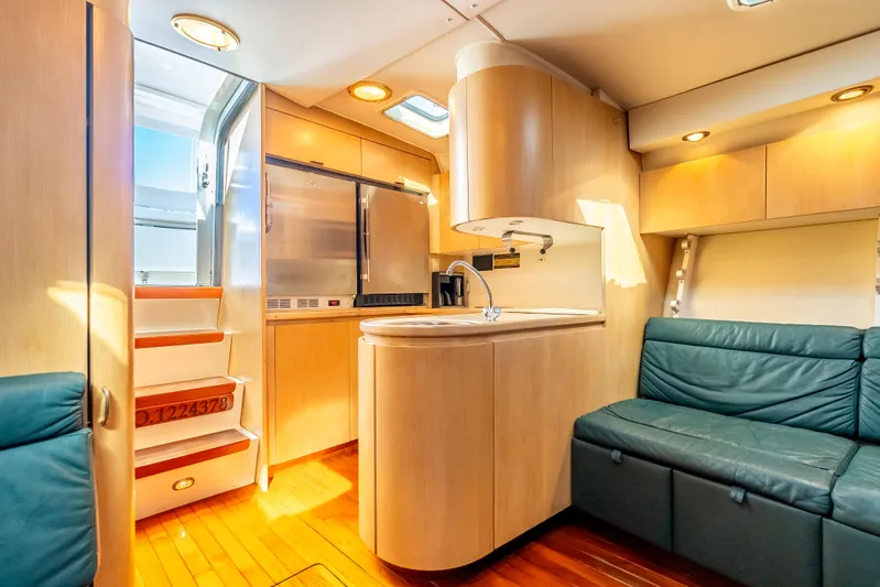 Magic Yacht Photos Pics Luxurious interior of 1992 Tiara Yachts 4300 Open with modern kitchen and seating area.