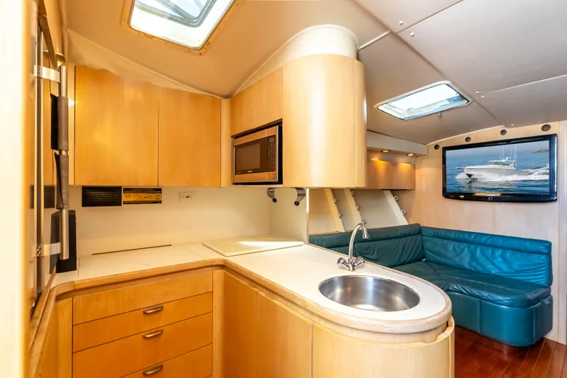 Magic Yacht Photos Pics Interior of 1992 Tiara Yachts 4300 Open with kitchenette and seating area.