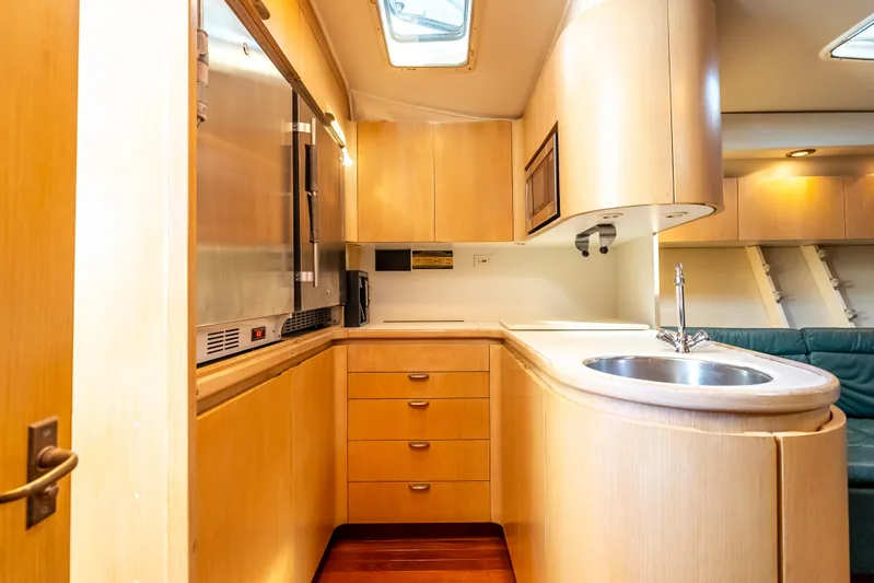 Magic Yacht Photos Pics 1992 Tiara Yachts 4300 Open interior kitchen with wood cabinetry and modern appliances.