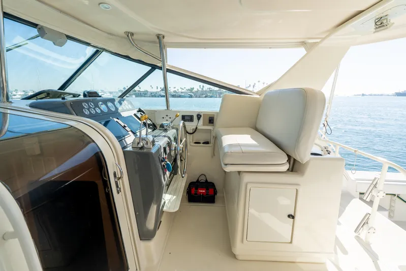 Magic Yacht Photos Pics 1992 Tiara Yachts 4300 Open cockpit with helm, seating, and ocean view.