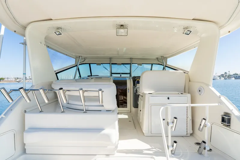 Magic Yacht Photos Pics 1992 Tiara Yachts 4300 Open interior with seating and helm, overlooking water.