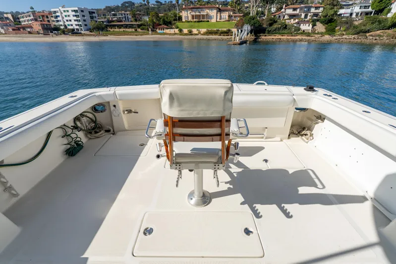 Magic Yacht Photos Pics 1992 Tiara Yachts 4300 Open deck with chair, overlooking serene waterfront homes.