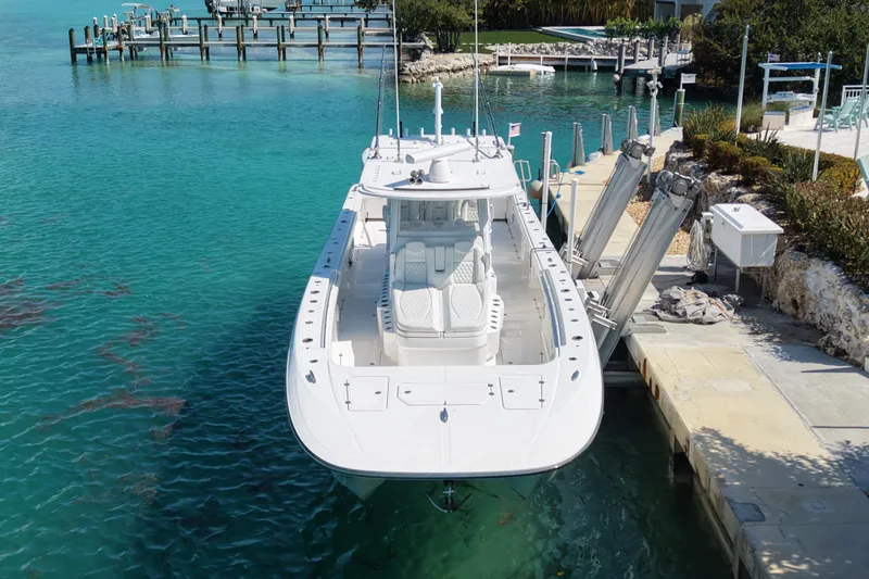  Yacht Photos Pics 2023 Invincible 46 Catamaran docked in clear turquoise water, showcasing sleek design.