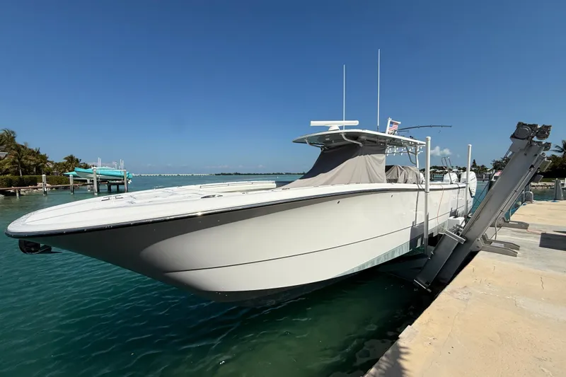  Yacht Photos Pics 2023 Invincible 46 Catamaran docked in clear blue water under a sunny sky.
