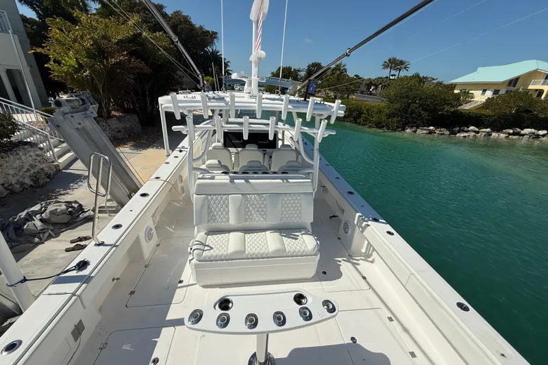  Yacht Photos Pics 2023 Invincible 46 Catamaran docked, showcasing spacious deck and seating area.