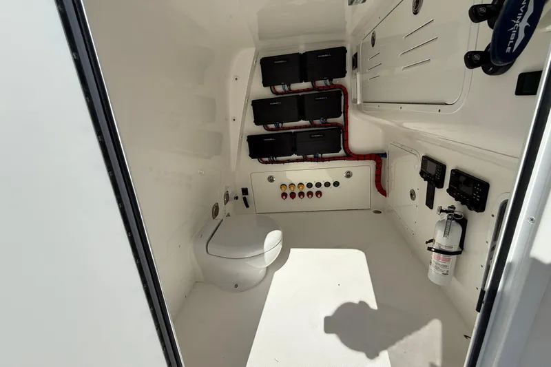  Yacht Photos Pics 2023 Invincible 46 Catamaran interior with toilet, control panels, and fire extinguisher.