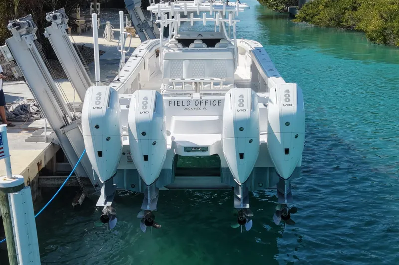  Yacht Photos Pics 2023 Invincible 46 Catamaran docked with four powerful outboard engines.
