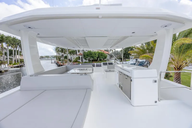  Yacht Photos Pics 2024 Leopard 53 Powercat yacht deck with modern seating and outdoor kitchen.