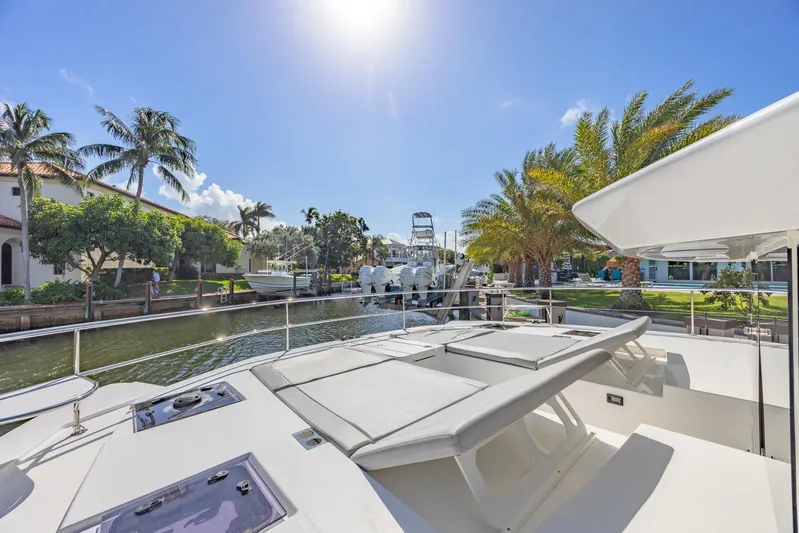  Yacht Photos Pics 2024 Leopard 53 Powercat yacht docked in sunny marina with palm trees.