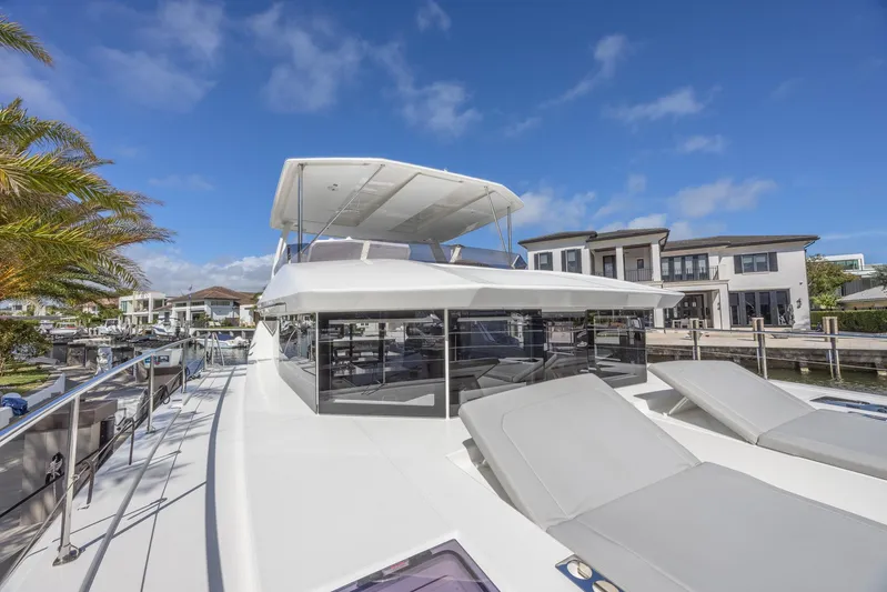  Yacht Photos Pics 2024 Leopard 53 Powercat yacht docked, featuring sleek design and spacious deck.